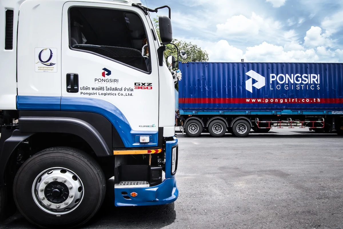 Pongsiri truck beside a branded container