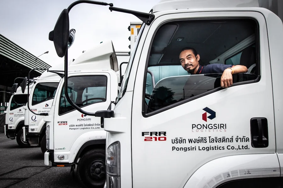Pongsiri driver in the cab of a delivery truck