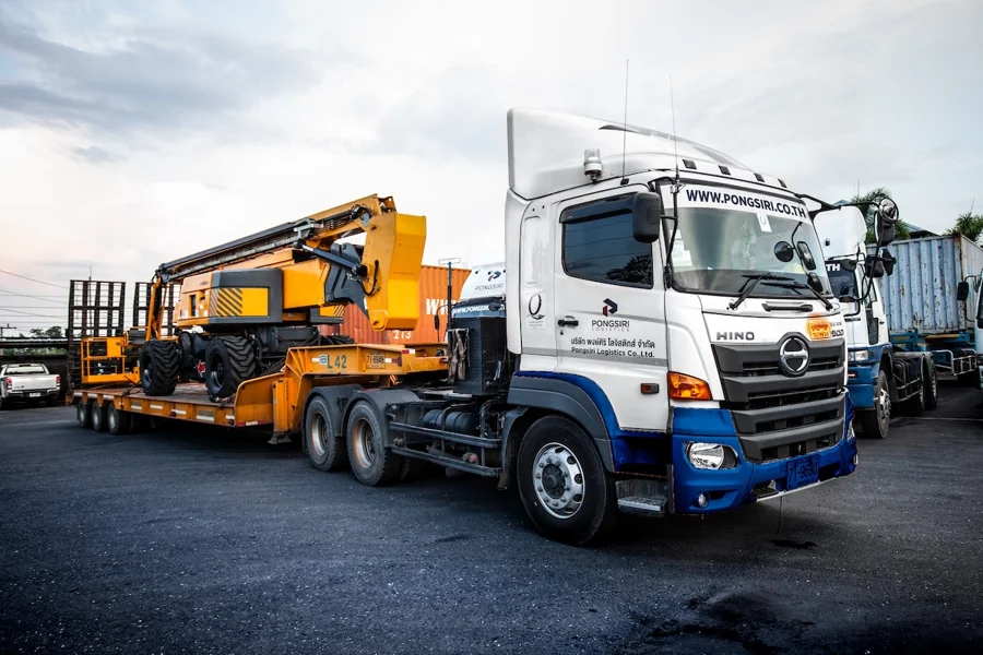 Heavy machinery transported on a Pongsiri lowbed trailer