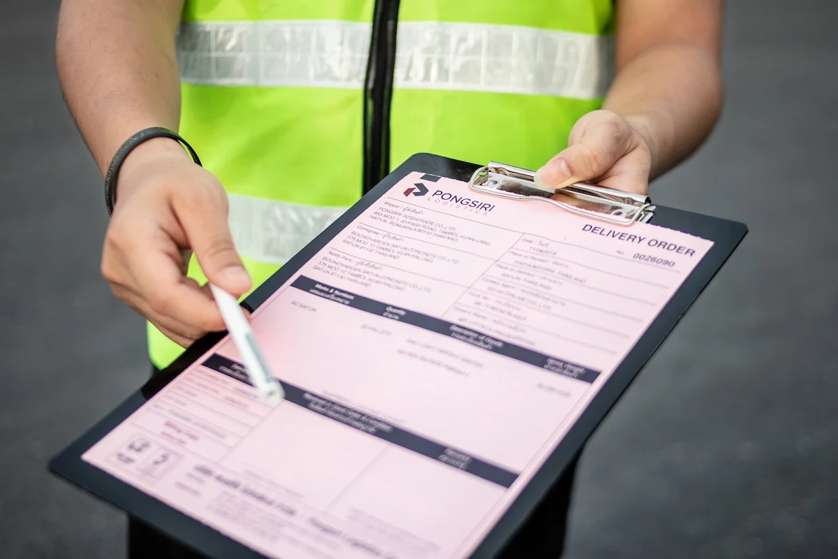 Team member reviewing shipment paperwork