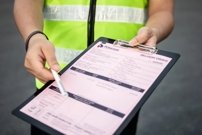 Team member reviewing shipment paperwork